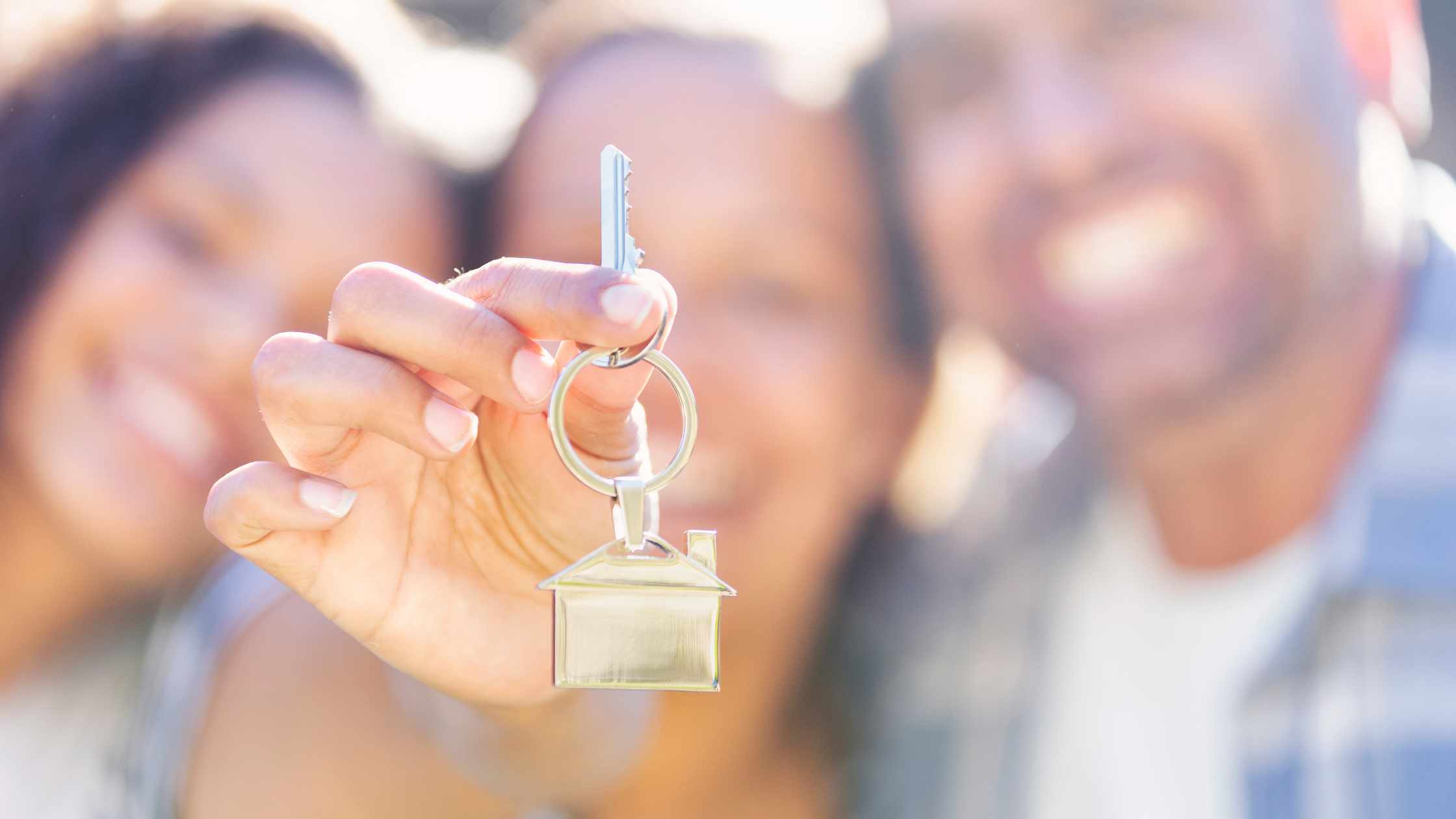 family holding key for their new house